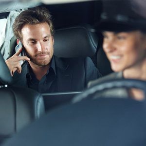 Man Speaking on Phone in Luxury Vehicle