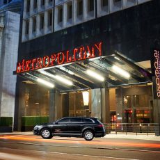 Black Luxury Vehicle Parked in Front of Metropolitan Building