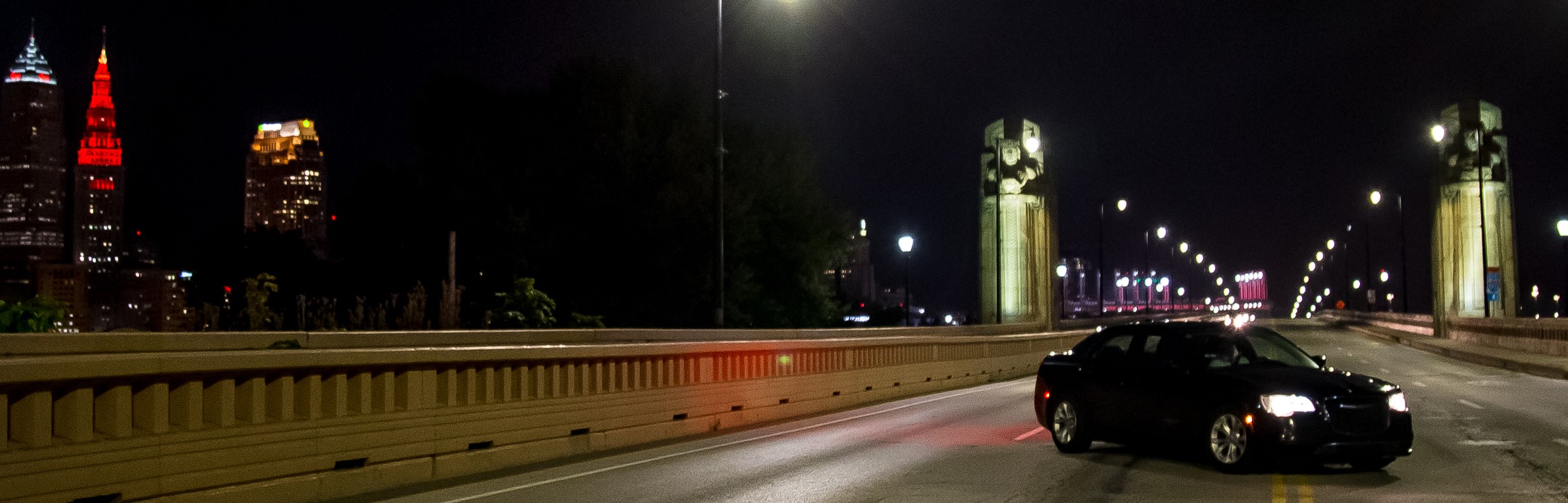 Black Luxury Vehicle Parked on Bridge